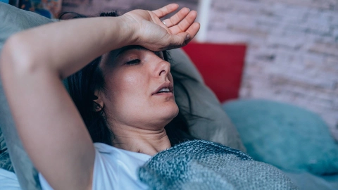 A woman lies exhausted on the couch.