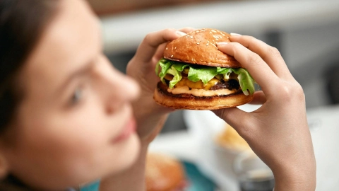 Young woman with burger