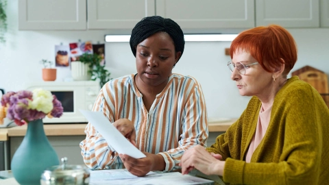 Two women looking at a form together