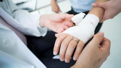 Erysipelas: man having his wrist dressed.